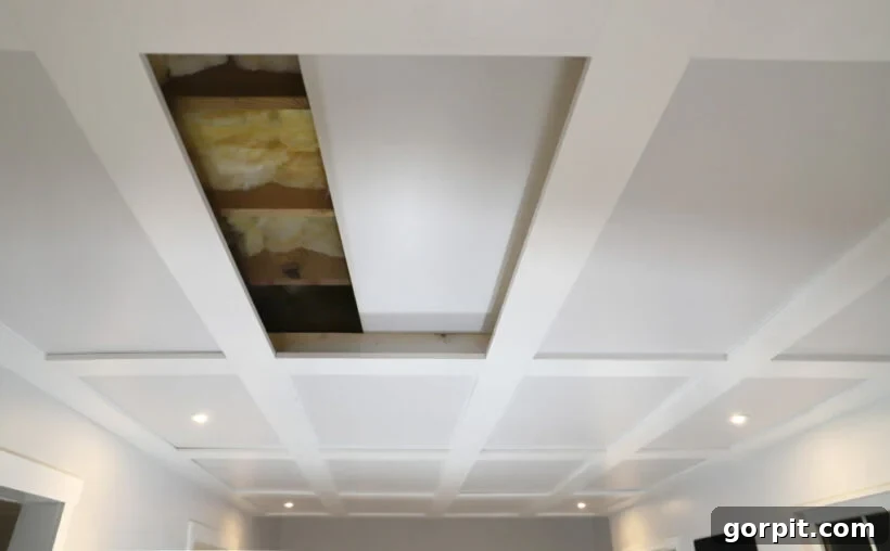 Basement room featuring a stylish DIY coffered drop ceiling, where the panels are designed to look like a coffered ceiling while retaining easy access for maintenance.