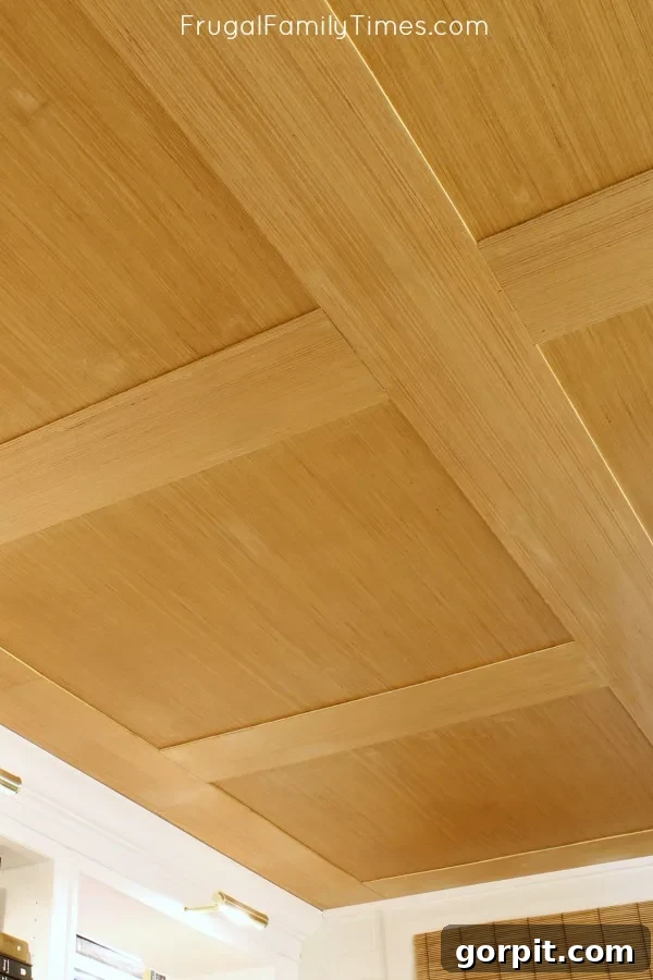 A finished basement ceiling made from DIY plywood panels, showcasing a clean, modern aesthetic that is both stylish and budget-friendly.