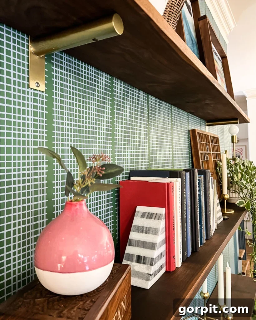 DIY wall shelves against a tastefully wallpapered accent wall