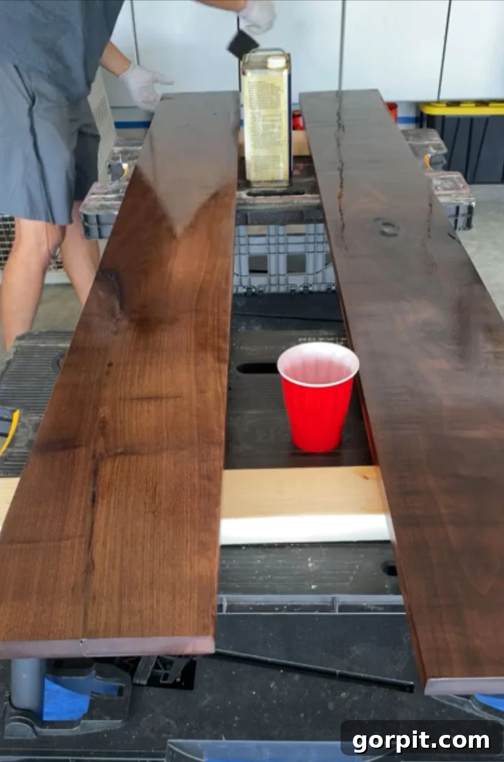 Applying Danish Oil to wooden shelves for a rich, protective finish