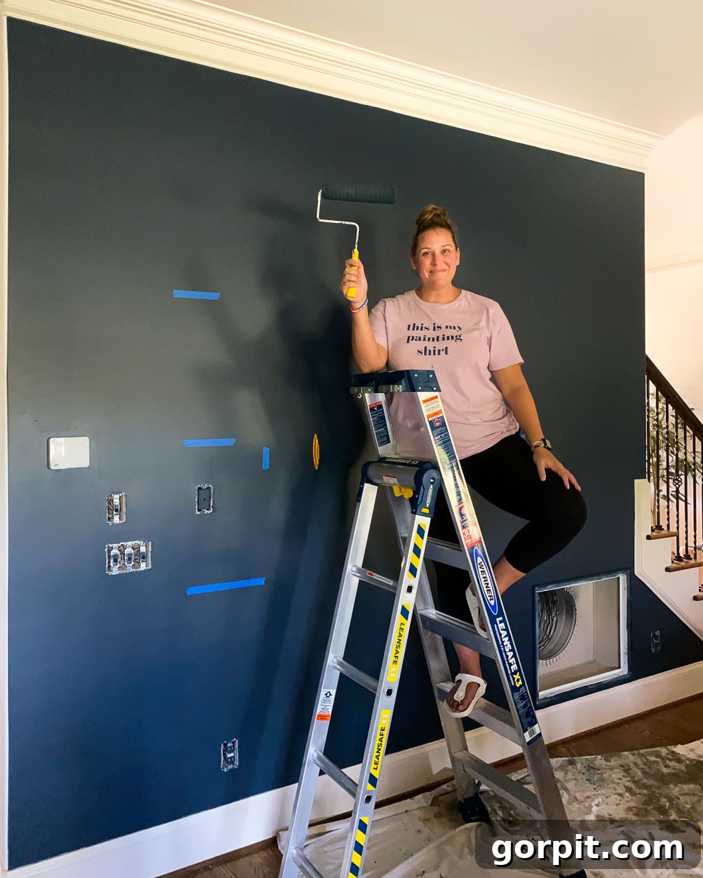 Marking wall studs and shelf positions using painter's tape for accurate installation