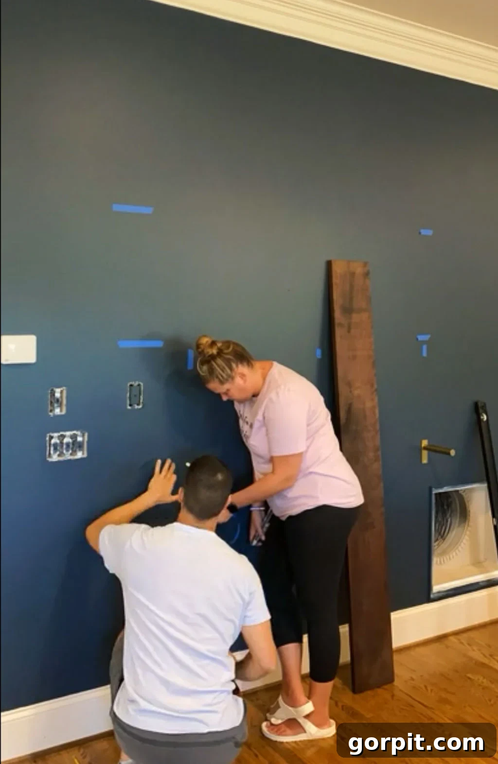 Installing sturdy shelf brackets onto the wall, secured into studs