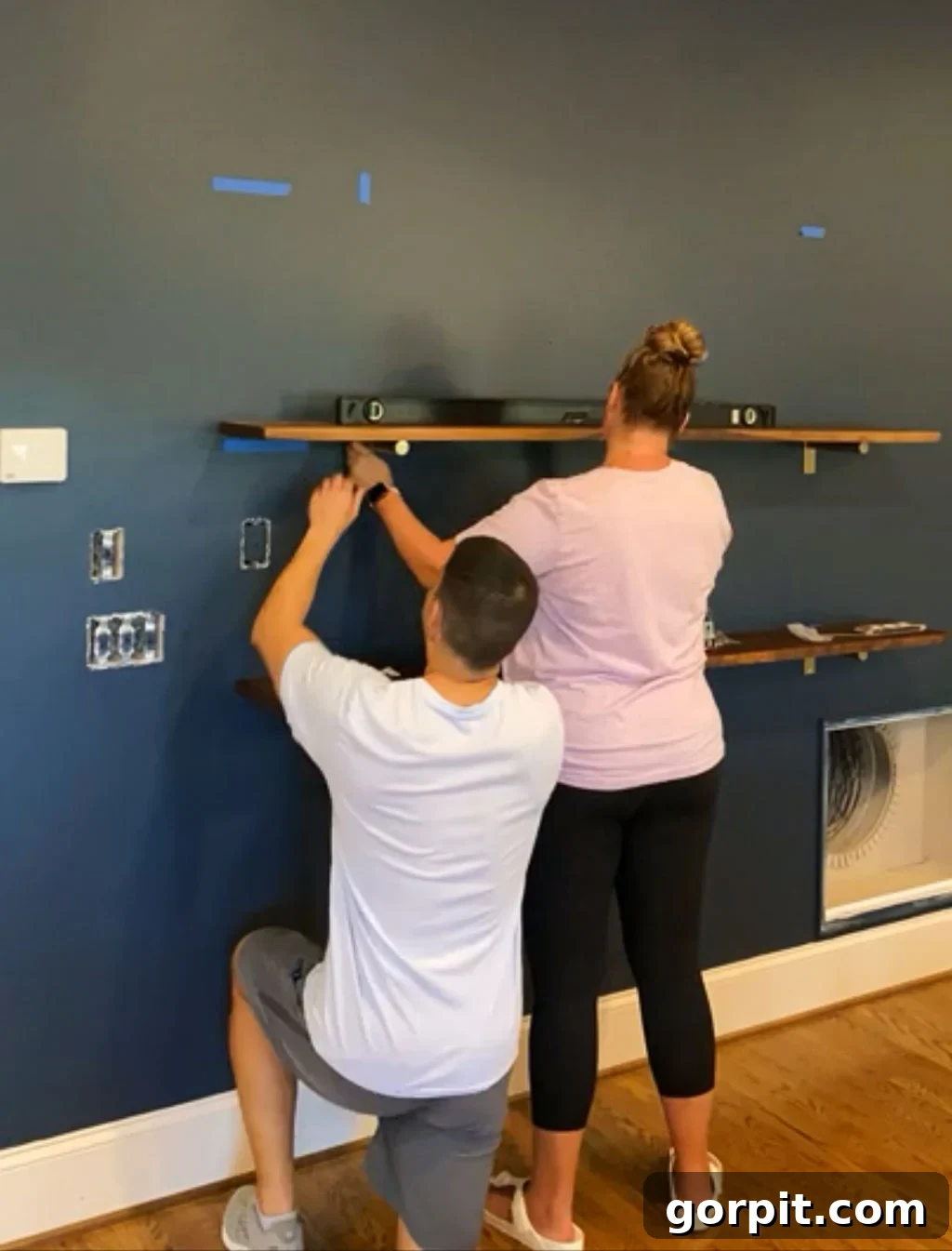 Securing the wooden shelves onto the installed brackets with set screws