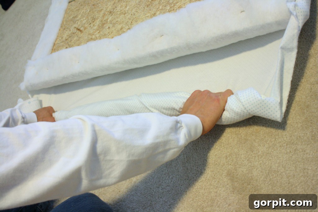 Upholstering the headboard with the chosen fabric