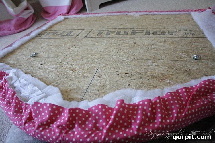 Detail of the fabric being stapled during re-upholstering