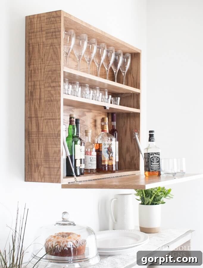Space-saving wall-mounted bar cabinet that partially closes, displaying glassware as decor