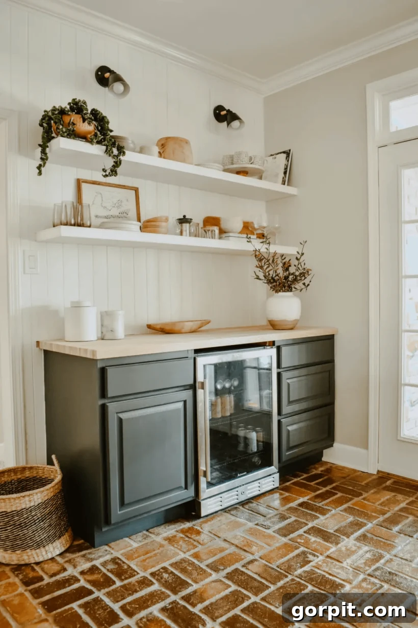 Luxurious DIY dry bar with custom paneling, open shelving, integrated refrigerator, and stylish black and brass lighting