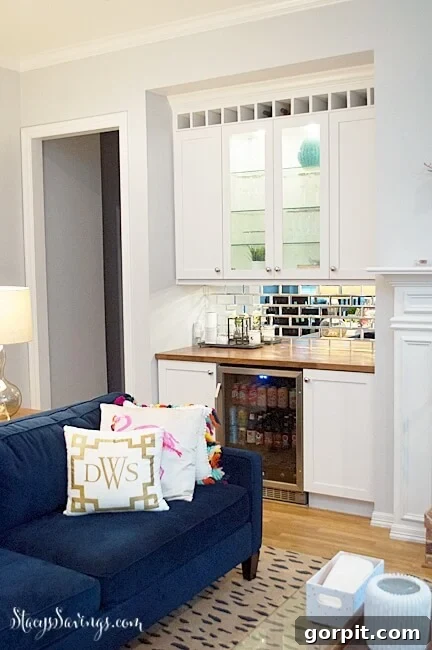 DIY built-in bar transforming an old media cabinet in a living room, featuring shelving and storage