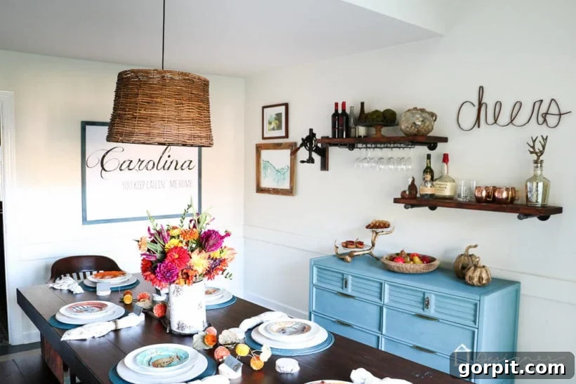 Dining room bar featuring a repurposed buffet table and industrial pipe shelves with hanging wine glass rack