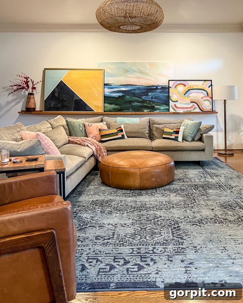 Effortless Budget DIY Canvas Frame 4 colorful family room with large art on art ledge, before framing
