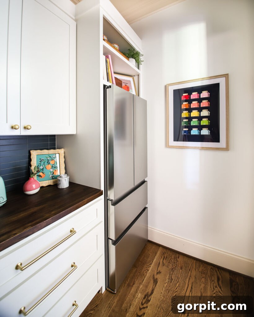 The finished colorful DIY butler's pantry, showcasing custom cabinets and integrated refrigerator.
