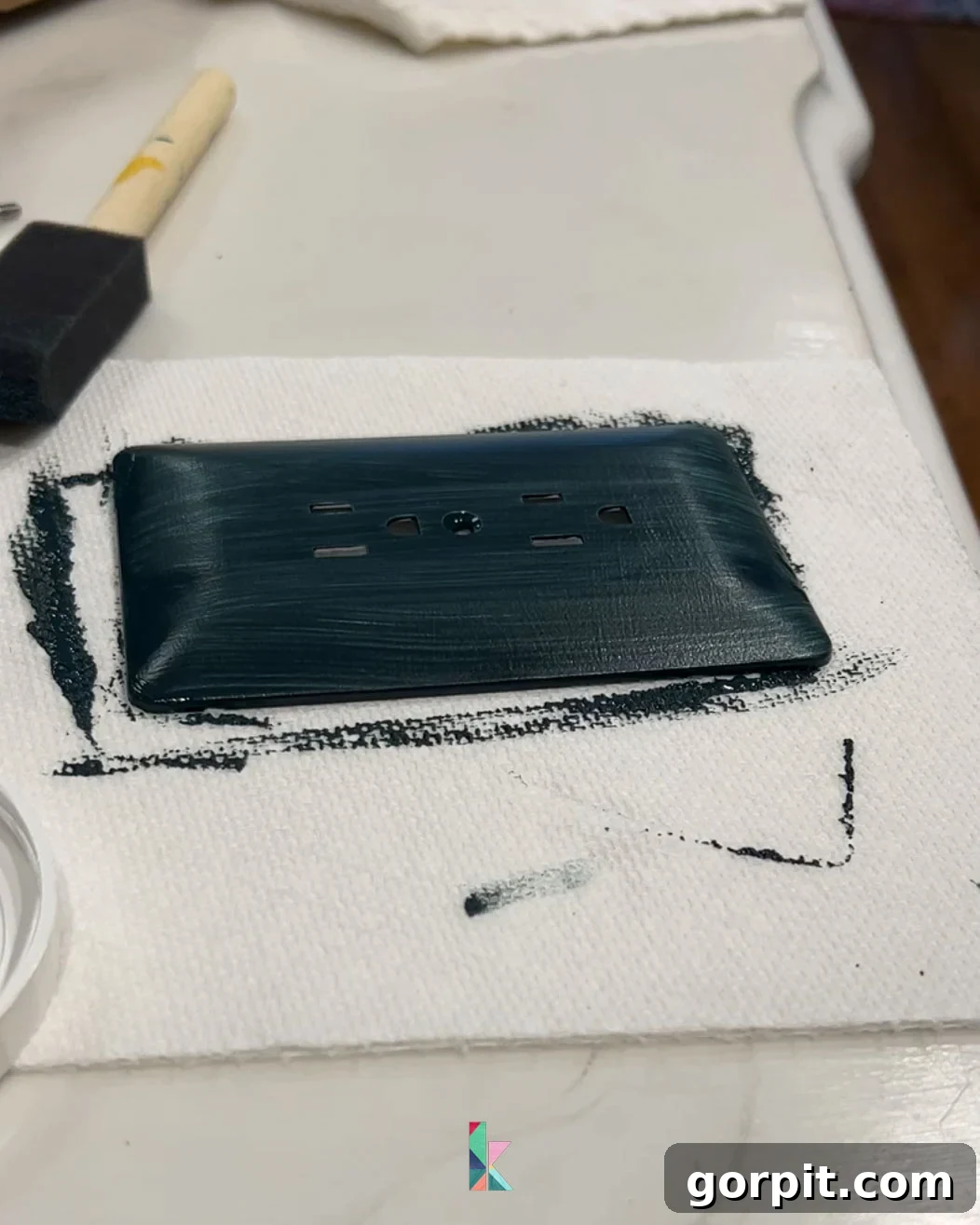 Painted outlet cover blending seamlessly with the backsplash tile, demonstrating a simple yet effective technique for a cohesive kitchen design.