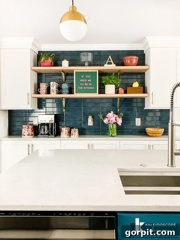 Spacious kitchen featuring a vibrant teal blue tile backsplash, complementing the kitchen's overall design and showcasing a large tiled area.