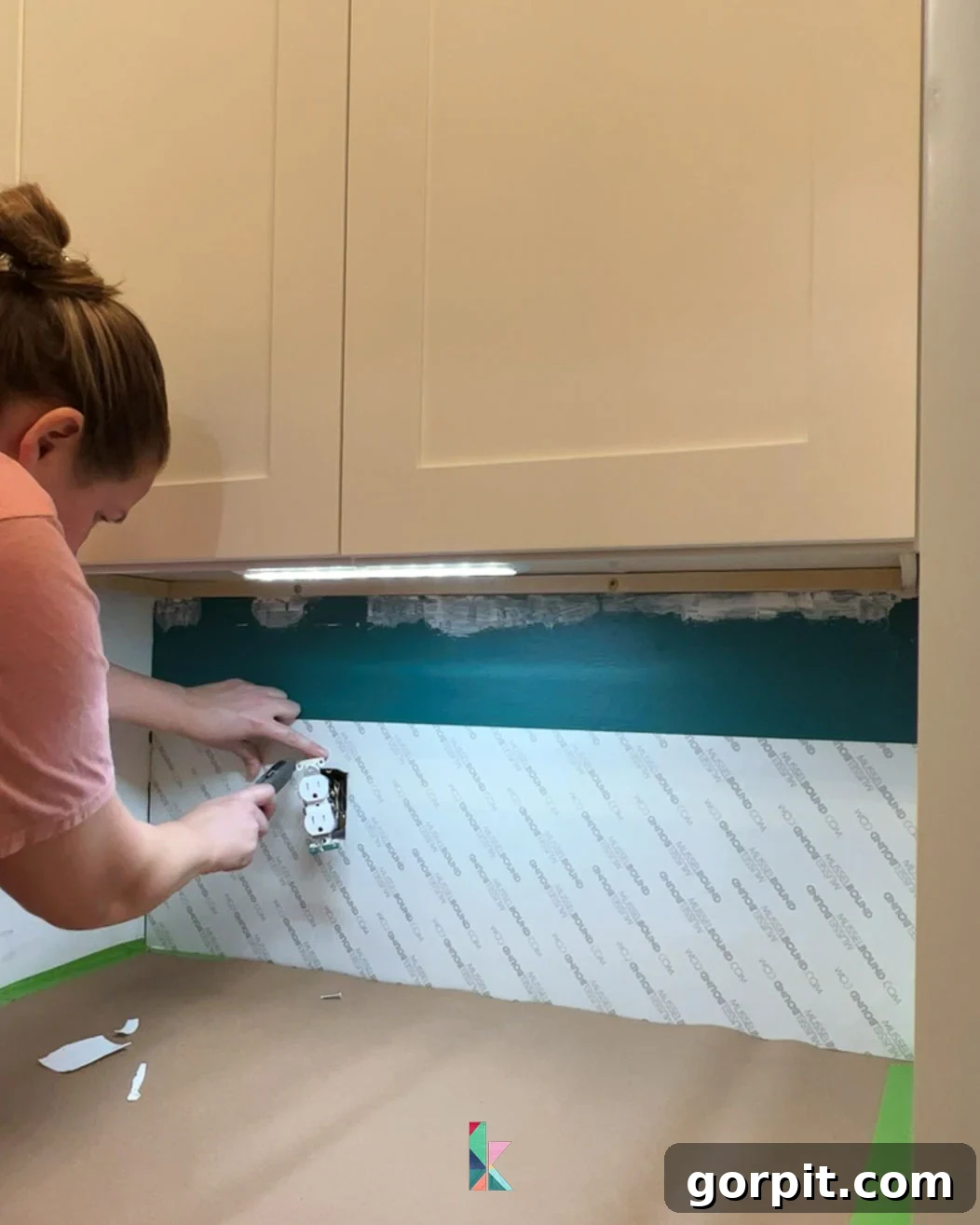 Installing MusselBound tile adhesive mat onto the backsplash wall, demonstrating a clean and efficient application method for tile installation.
