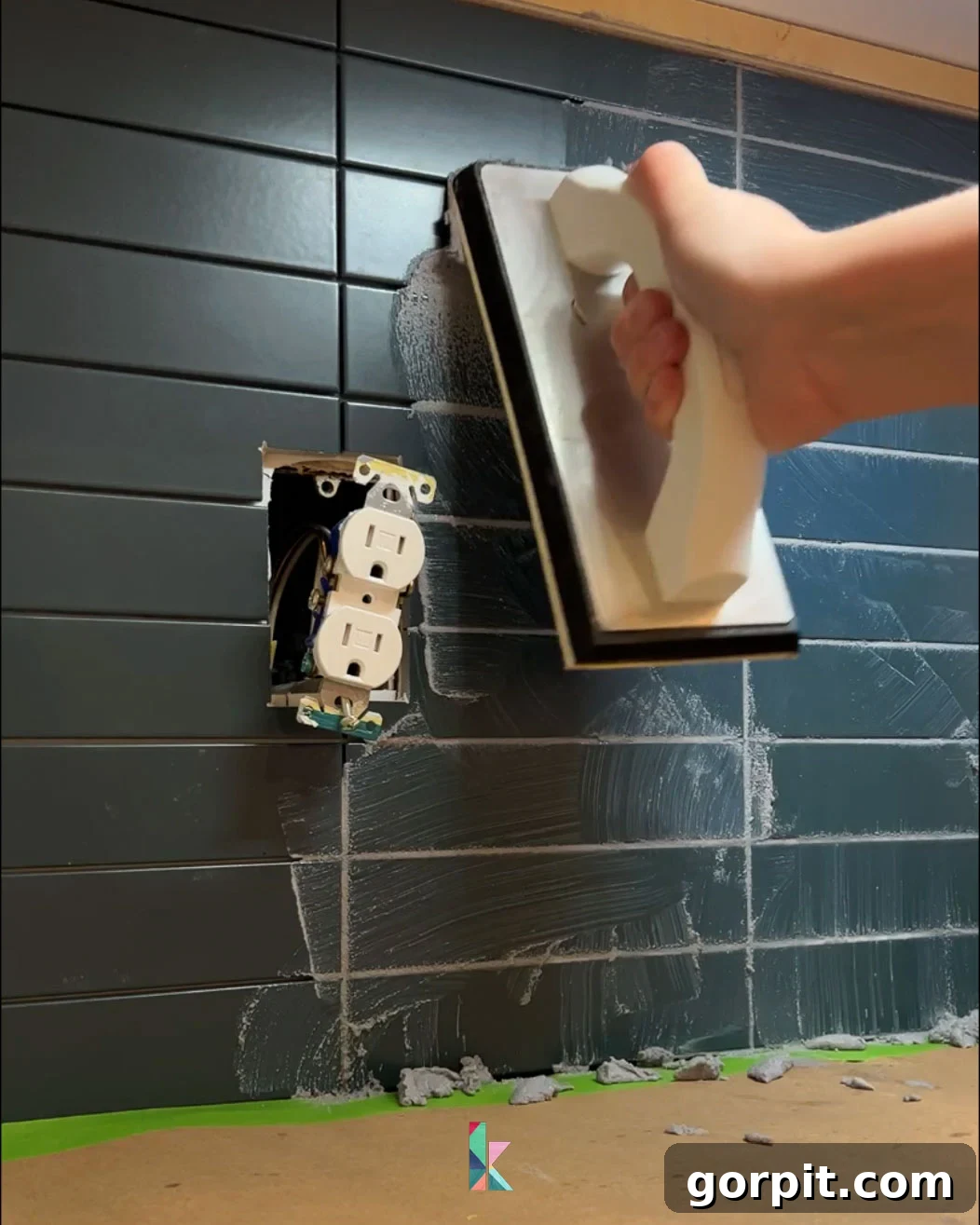 Grouting backsplash tile with a grout float, illustrating the proper technique for filling joints and removing excess for a smooth finish.
