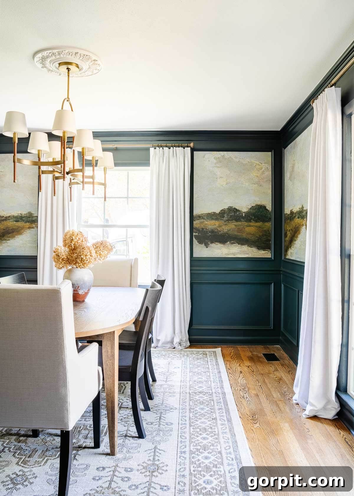 Navy dining room walls featuring Blue Ridge Parkway paint, complemented by a landscape wallpaper mural and an elegant dining room table and area rug, creating a stunning and dramatic makeover.