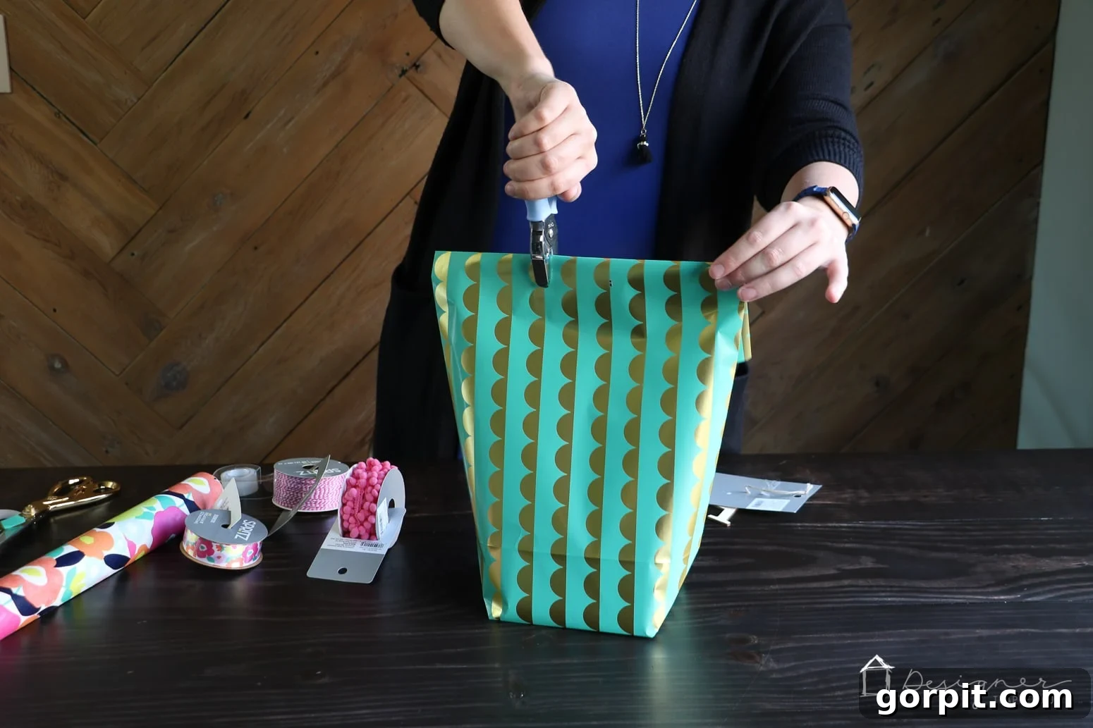 Close-up of the punched holes in the top of the DIY gift bag, ready for ribbon insertion.