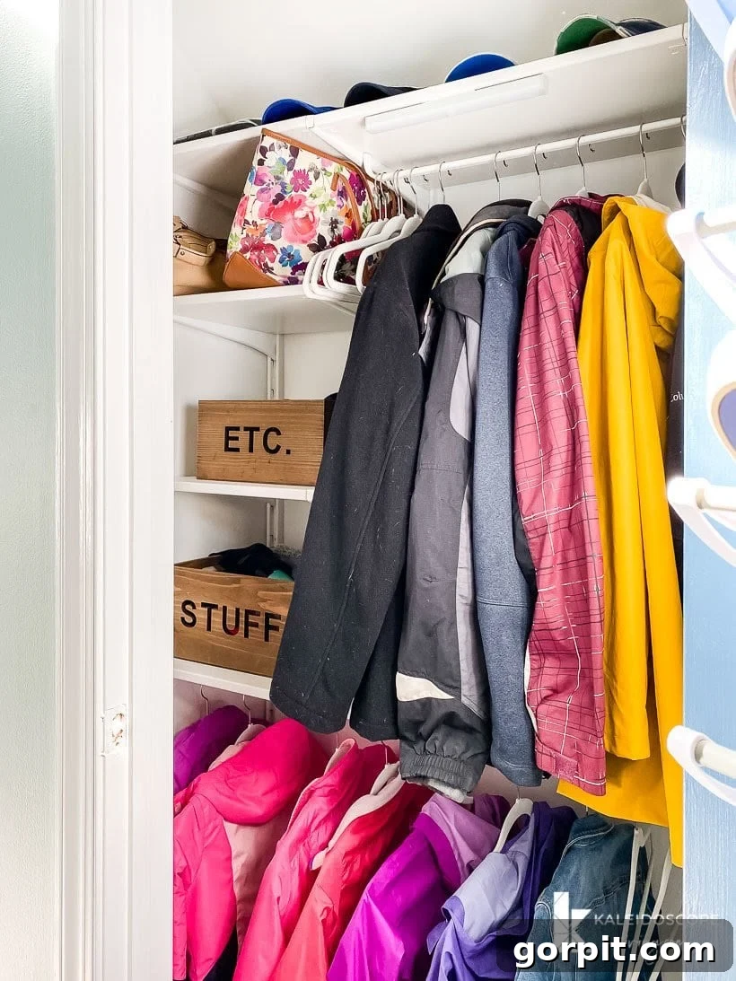 Transform Your Closets: 7 DIY Makeovers Using Our Favorite Systems 10 A renovated coat closet uses the IKEA Boaxel system to allow for two rods to hang coats up and shelves along the side with wood boxes that say "Etc." and "Stuff."