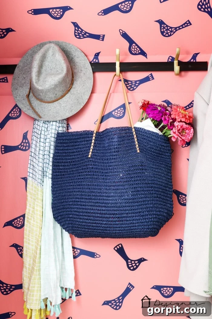18 Wallpaper Gems to Transform Your Digital Space 12 A small closet adorned with DIY faux wallpaper created using navy blue vinyl bird decals, providing a charming and removable wall treatment.