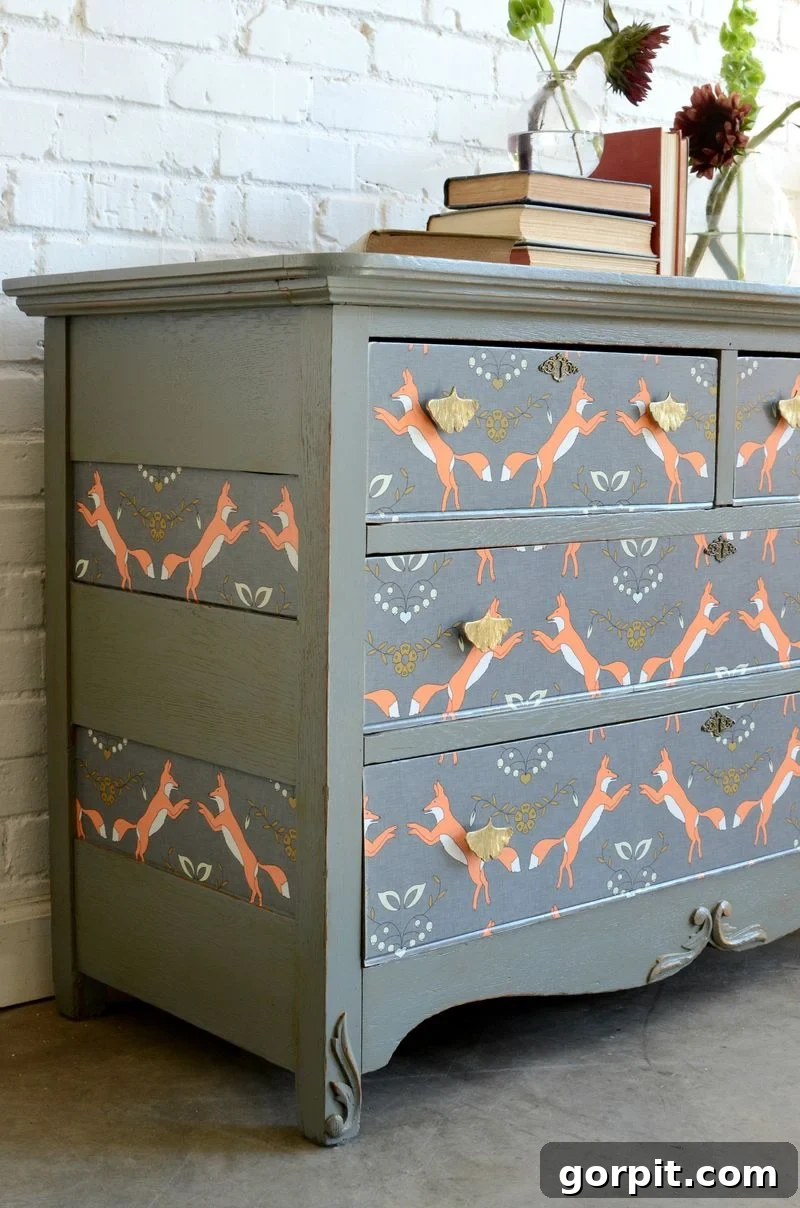 18 Wallpaper Gems to Transform Your Digital Space 13 A child's dresser beautifully decorated with whimsical wallpaper on the drawer fronts, adding a playful and personalized touch to the room.