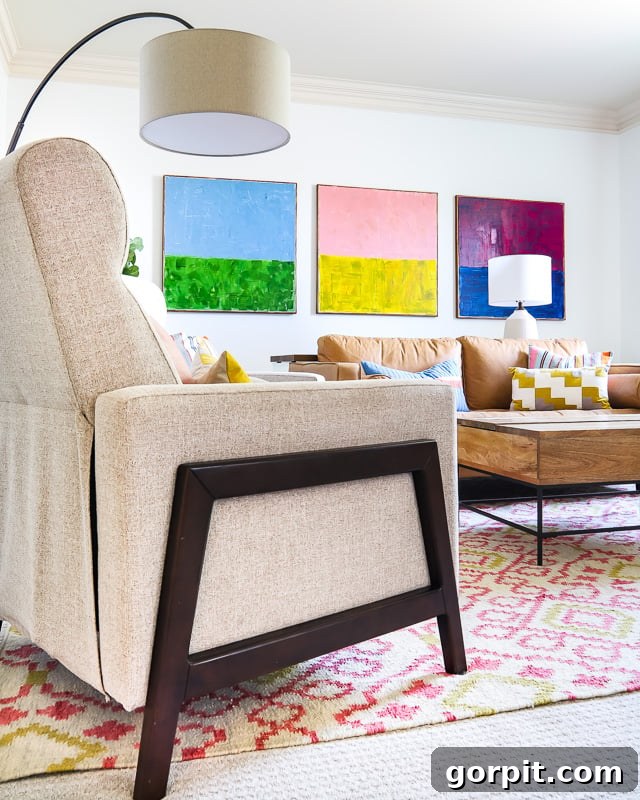 family room with large pink and yellow area rug and colorful art pieces and decor