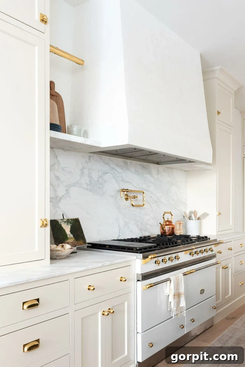 Timeless Neutral Colors for Stunning Kitchen Cabinets 5 Creamy White by Benjamin Moore on cabinets with white vent and marble backsplash