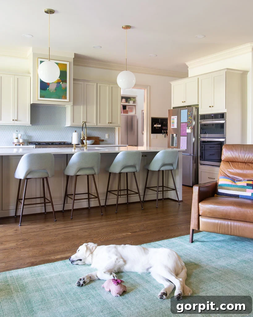 Timeless Neutral Colors for Stunning Kitchen Cabinets 10 colorful great room open to kitchen with cabinets painted Accessible Beige by Sherwin Williams