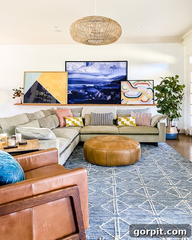 A bright living room with a blue West Elm graphic diamond affordable area rug, demonstrating West Elm's modern designs.