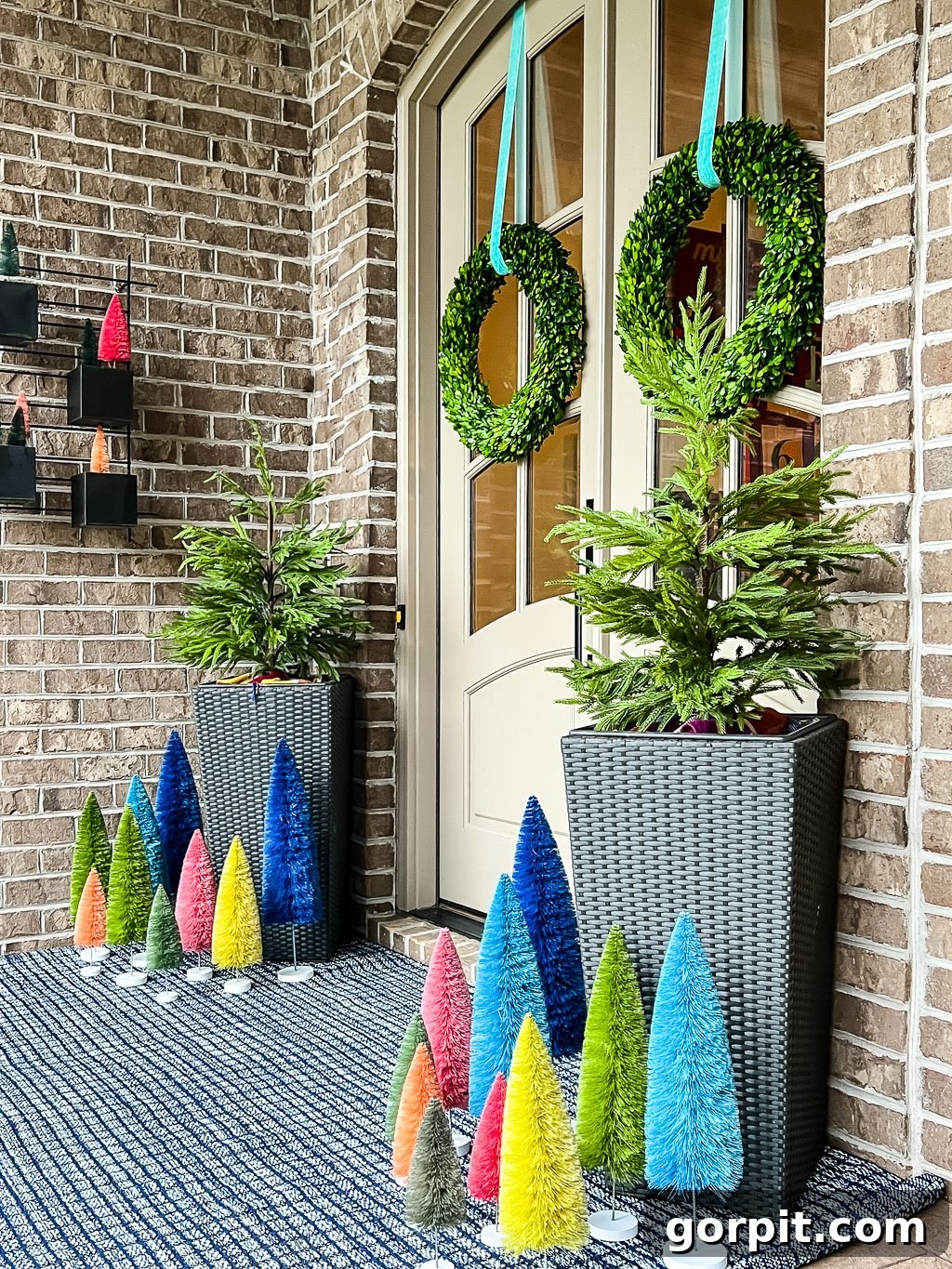 A front porch has colorful Christmas decorations and an Annie Selke rug, demonstrating its durability.