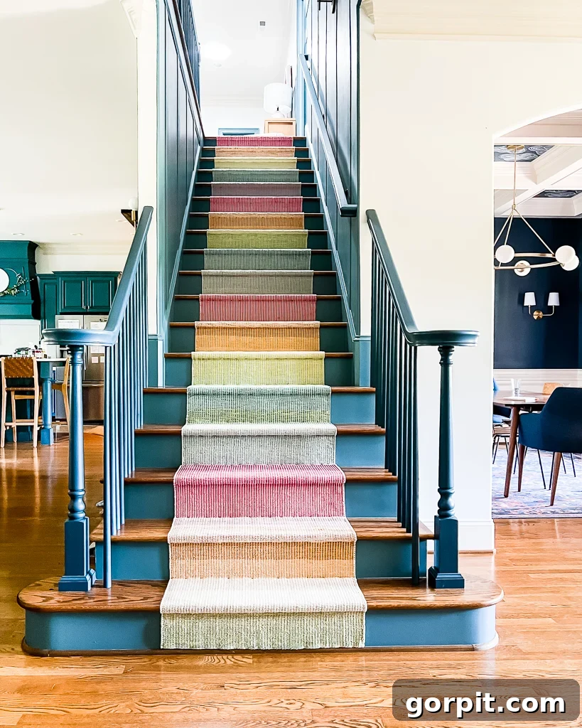 Blue and wood stairs create a focal point with the Annie Selke multicolor, bright staircase runner, a DIY installation.