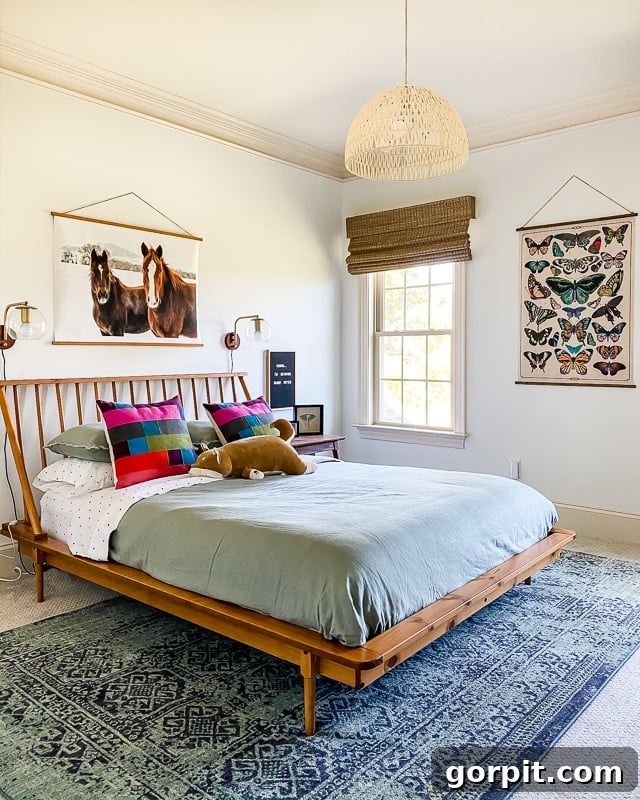 An 8' x 10' affordable area rug under queen bed and over carpet in girl's bedroom, showcasing Target's versatile designs.