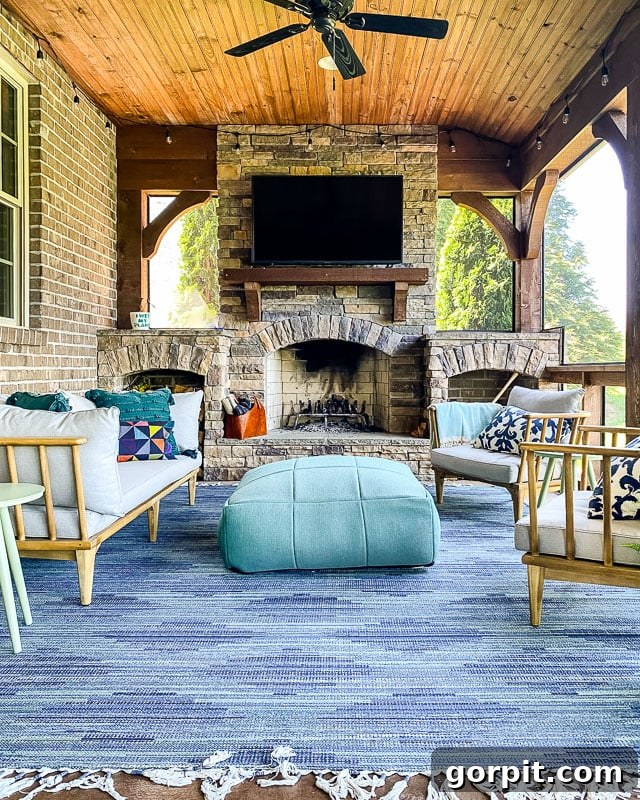 An indoor-outdoor rug on screened in porch in front of a brick fireplace, demonstrating Target's durable options.