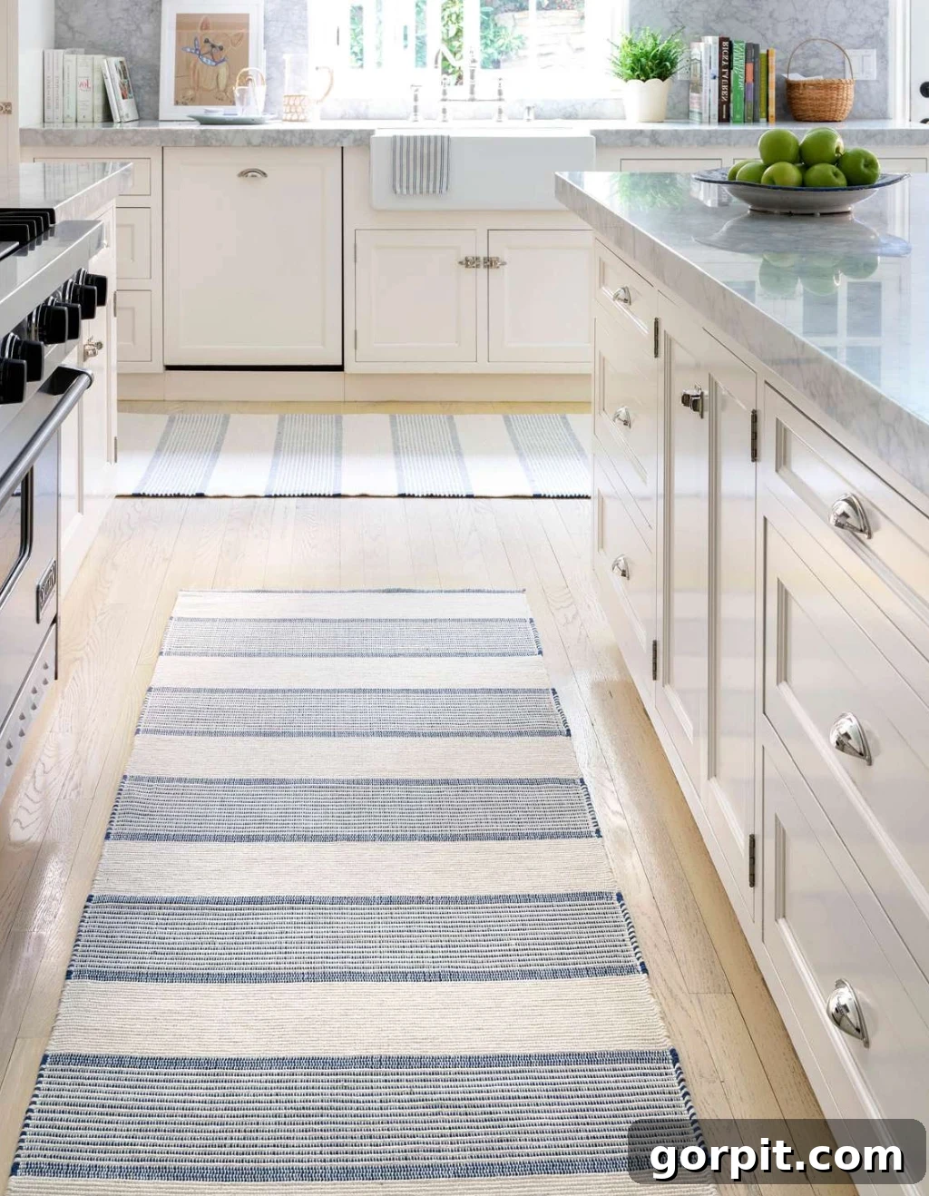 Elevate Your Kitchen Runner Style 7 Two striped cotton kitchen rug runners form a "T" in a white and marble modern kitchen.