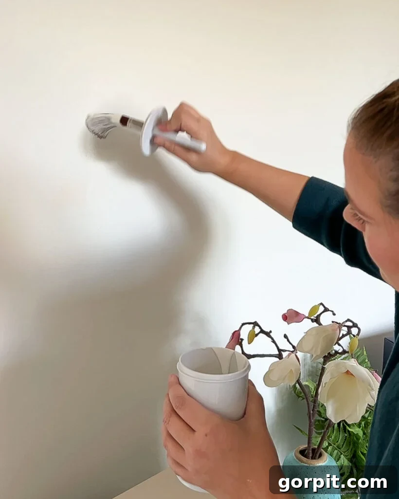 Seamless Wall Paint Repairs 3 woman touching up paint on white wall