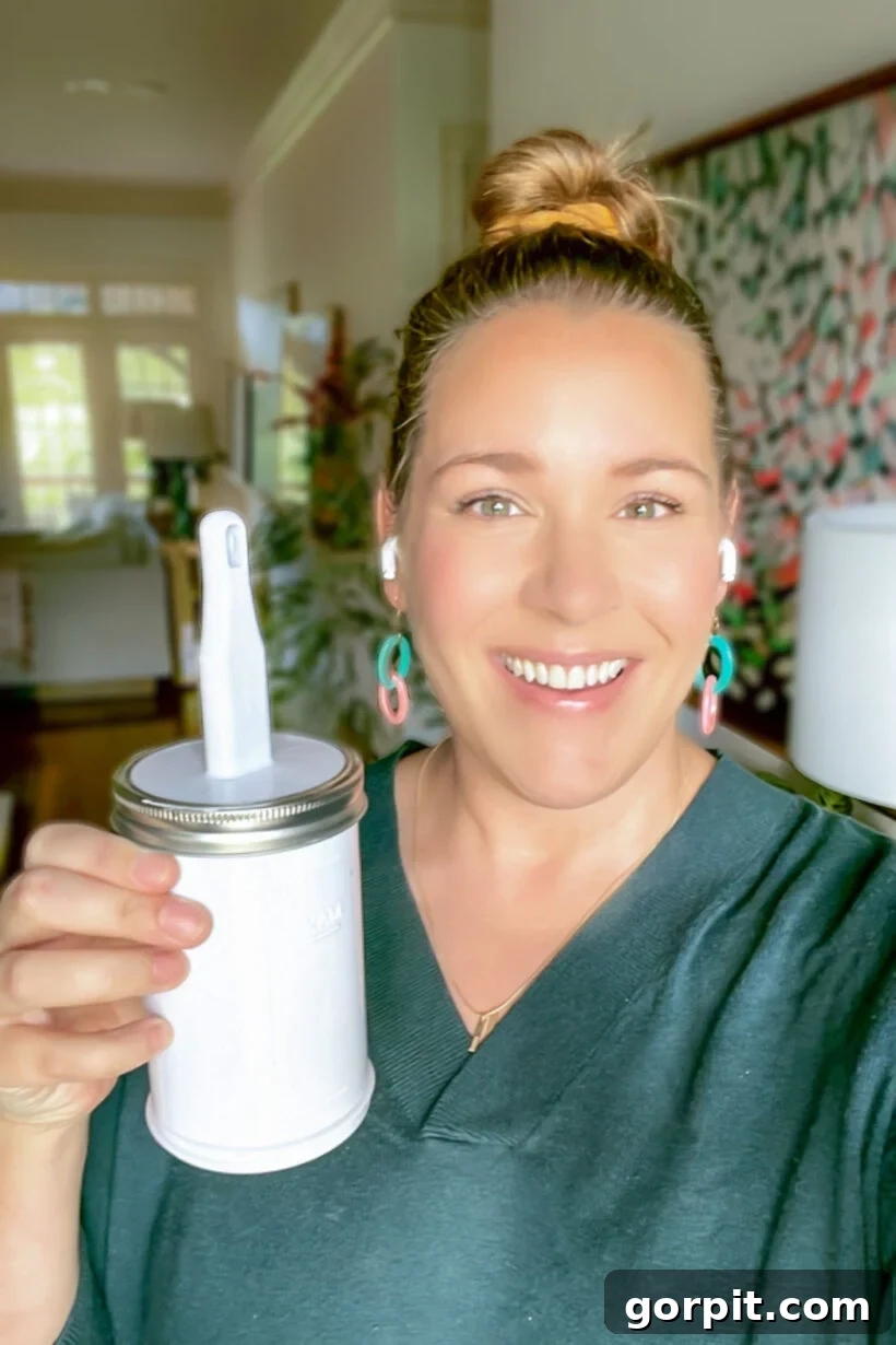 Seamless Wall Paint Repairs 6 Tasha Agruso of Kaleidoscope Living holding Paint Saint can for paint touch ups