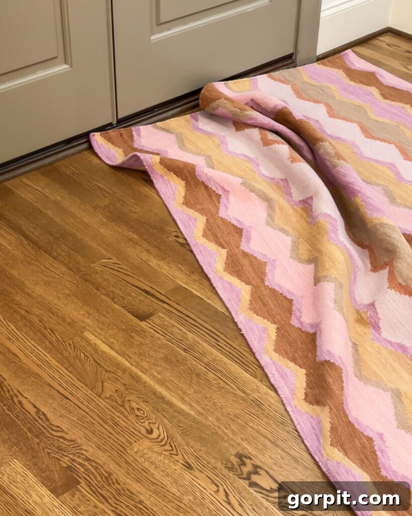 End Curling Rug Corners Smart Solutions for Every Home 6 bunched up pink patterned rug in front of door