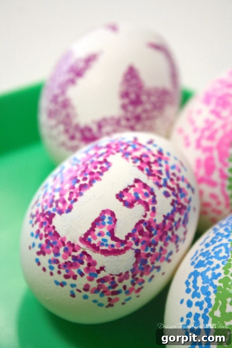Sharpie Dot Art Easter Eggs 7 A collection of beautifully decorated dotted Sharpie Easter eggs with various sticker shapes and color combinations.