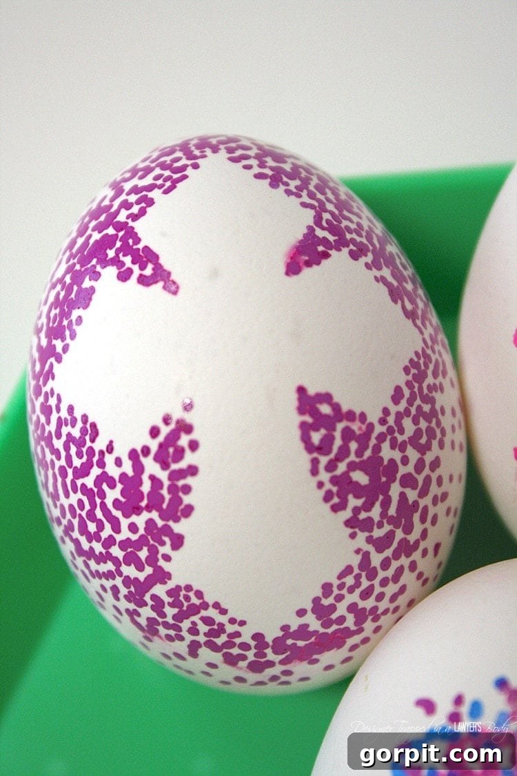 Sharpie Dot Art Easter Eggs 8 A close-up view of several finished dotted Sharpie Easter eggs, showcasing intricate patterns and vibrant colors, perfect for Easter decor.