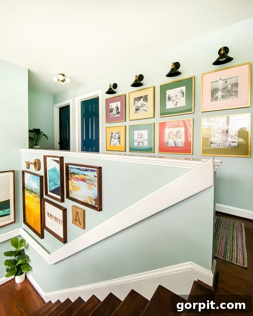 A flat banister, painted white, extends up a light-blue accent wall for a striking and modern, baluster-free look.