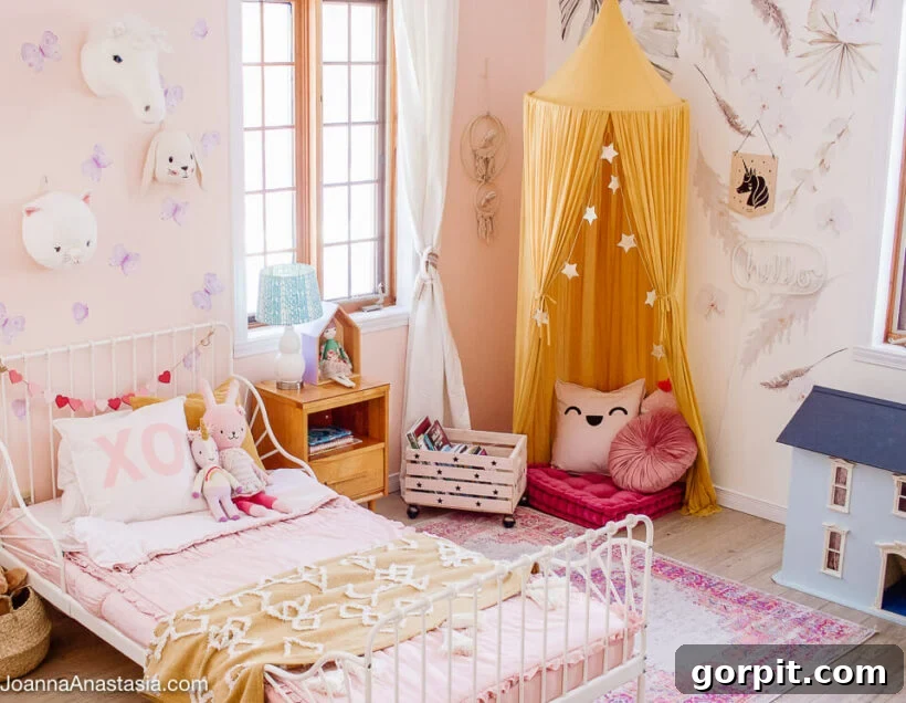 feminine little girls room with white iron toddler bed and reading nook with canopy, encouraging literacy