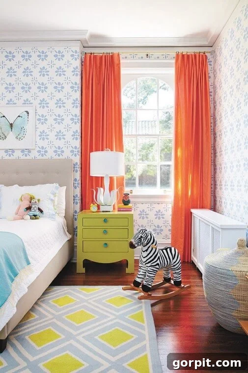 bedroom with periwinkle block print flowered wallpaper, bright orange curtains and pops of teal and chartreuse, an unexpected color scheme