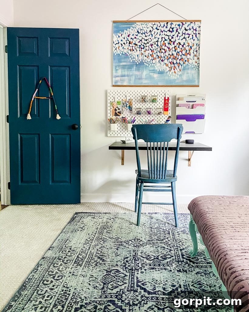 study area with floating desk and area rug over carpet in girl's bedroom, promoting productivity