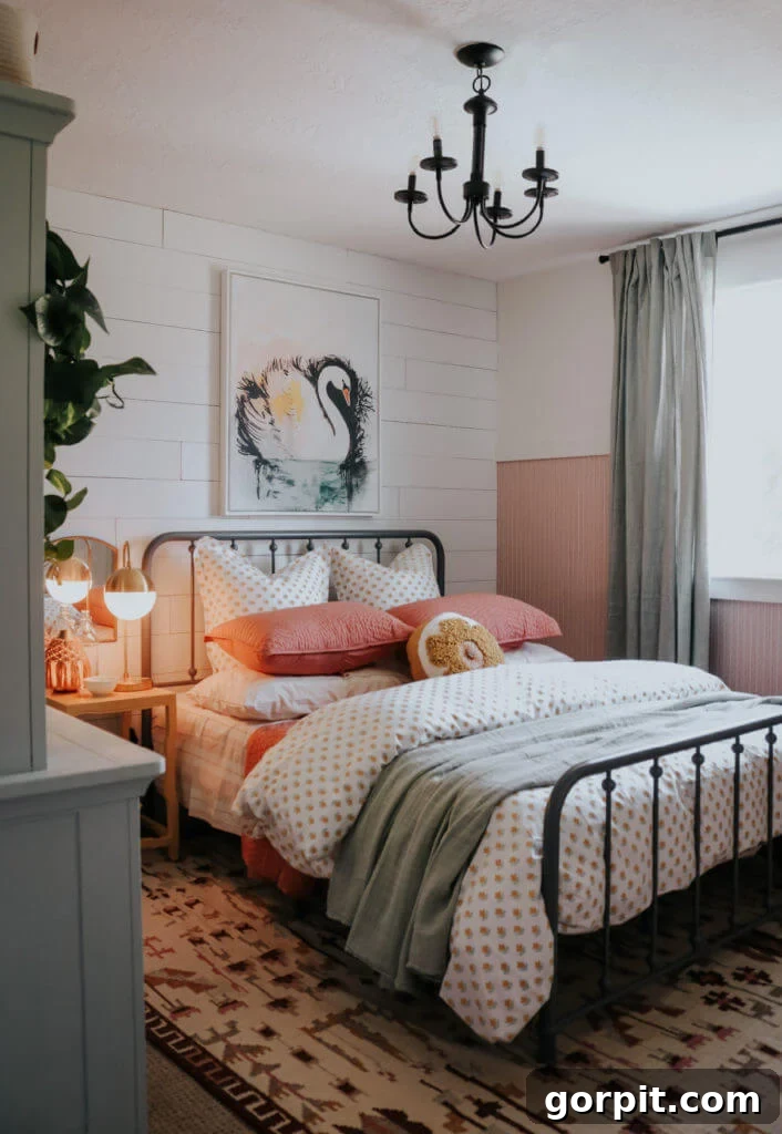 small neutral farmhouse girl's bedroom with blush bead board and swan painting over bed, optimized for compact living