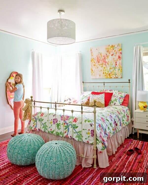 bright floral girl's bedroom with vintage iron bed and bright pink rug, blending old and new