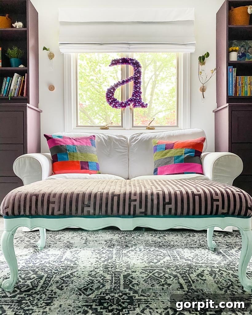 Elevate Your Decor with Handmade Giant Letters 17 A large DIY wall letter gracefully hanging in the window of a girl's bedroom, adding a bright focal point.