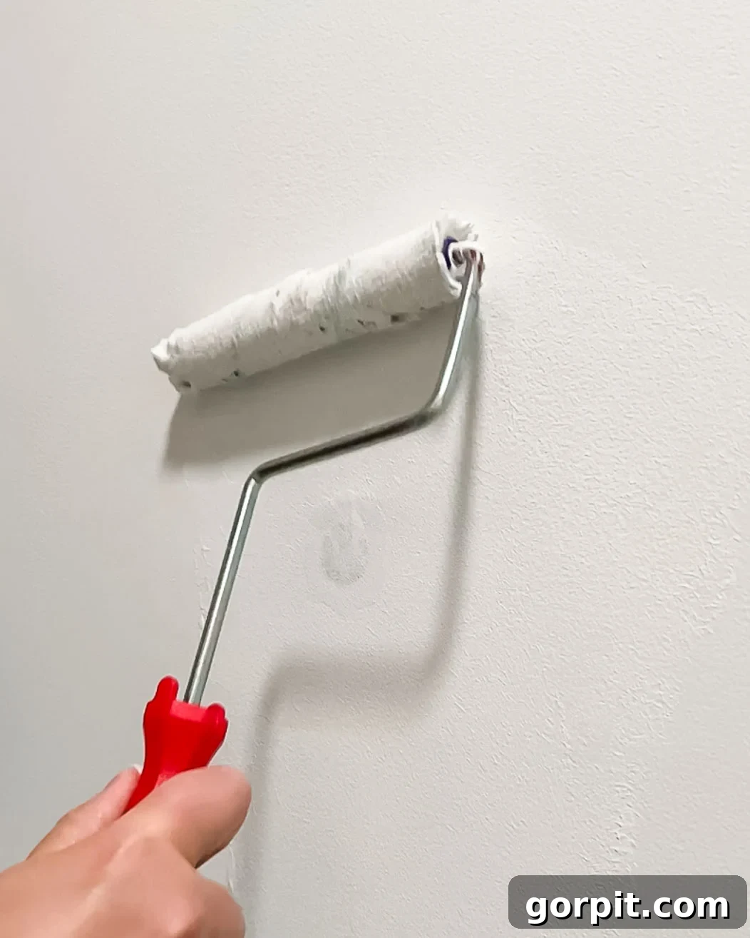 woman painting over DAP Eclipse wall repair patch
