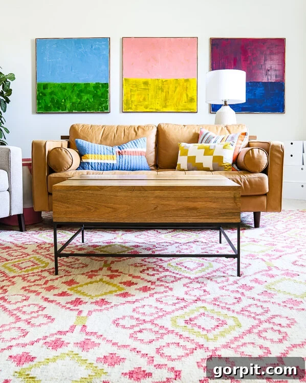 colorful family bonus room with tan leather couch and colorful abstract art hanging over it