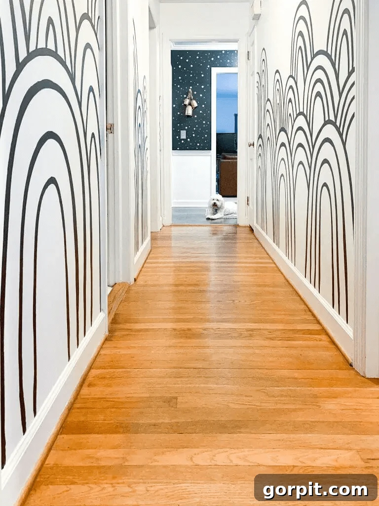 Black and white rainbow mural down a hallway
