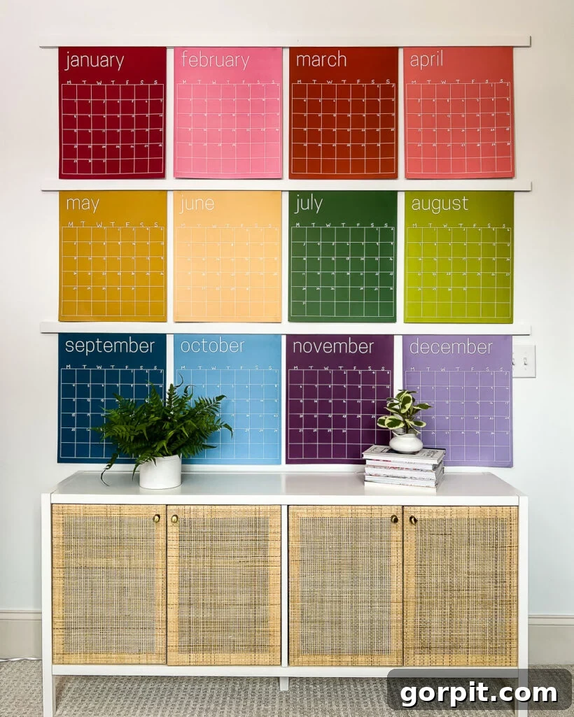 wall of giant rainbow wall calendars over a cabinet 