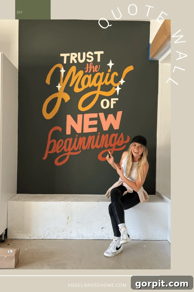large hand painted wall quote in garage that says 'Trust the Magic of New Beginnings' with woman sitting in front of it